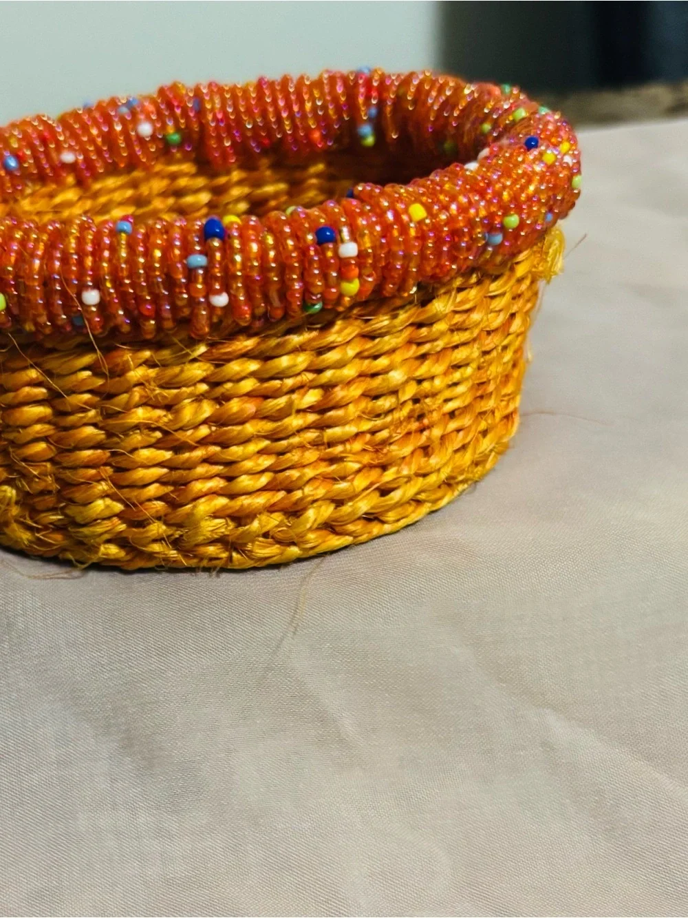 Handwoven Orange Jewelry Basket with Beaded Accent